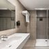 Exe São Lázaro in Bragança bathroom with walk-in shower, large mirror and modern sink