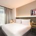 Adina Apartment Hotel Hamburg Speicherstadt guest room with king bed and large window in Hamburg