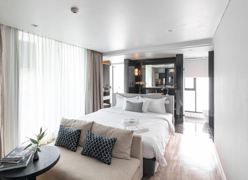 Apartelle Jatujak Hotel in Bangkok: bright guest room with bed, sofa, and floor-to-ceiling curtains