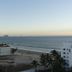 Hotel Playa Bonita in Mazatlán with oceanfront view, sandy beach, and palm trees at sunset