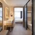 Hanting Hotel Zibo Jinjing Avenue Municipal Government guest room with desk and glass bathroom