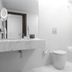Bathroom at Hotel Dom Goncalo & Spa in Fátima with marble sink, toilet, and bathtub with shower
