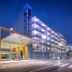Hotel Alhambra in Santa Susanna at dusk, showing a modern glass entrance and illuminated balconies