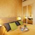 La Corte degli Spada - Borgo Antico del Salento in Mesagne bedroom with yellow bedspread, tray, and mirrored wardrobe