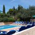 Apartments Antonio in Cavtat with outdoor pool, blue lounge chairs, and sun umbrellas