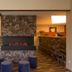 Hotel Olympia in Bruges lobby with fireplace, staircase, seating area and reception desk