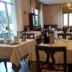Hotel Garden in Torri Del Benaco dining room with set tables, chandelier, and large windows