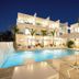 Seascape Hotel in Providenciales with a lit outdoor pool and sun loungers at dusk