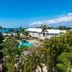 Margaritaville Beach Resort Grand Cayman in George Town with ocean view, pool and tropical palm trees