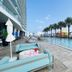 Lyfe Resort And Residences, Hollywood: rooftop pool with palm trees, lounge chairs and city view