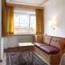 Christophorus Mountain Residence in San Vigilio di Marebbe living area with sofa, TV, and window view
