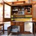 Hospedium Hacienda Las Cavas in Olmedo with rustic kitchenette, open cabinets and wood stove