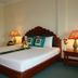 Majestic Oriental Hotel Siem Reap guest room with twin beds, bedside lamps and floral decor
