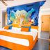 Diver Roquetas in Roquetas de Mar: bright bedroom with orange-and-white beds and colorful wall mural
