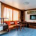 Hua Hin Loft in Hua Hin hotel room with TV, seating area, desk, and mini fridge