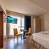 Ddream Hotel in St. Julian's room with twin beds, balcony, wall-mounted TV and sea view