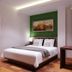 Neotel Hotel City Centre, Tanjung Redeb guest room with bed, desk, and window with curtains
