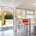 Première Classe Châlons-en-Champagne breakfast area with colorful stools and glass doors to outside, Saint-Martin-sur-le-Pré