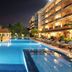 Somadevi Angkor Premium in Siem Reap: night view of a lit outdoor pool beside the hotel