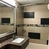 Red Carpet Inn Elmwood Park bathroom with granite vanity, mirror, tiled tub shower and towel rack