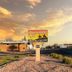 Trail Rider's Inn in Tombstone roadside motel sign at sunset with desert landscaping