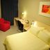 Jinjiang Inn (Huizhou Dadao Hefei) guest room in Hefei with bed, desk, red chair and wall art