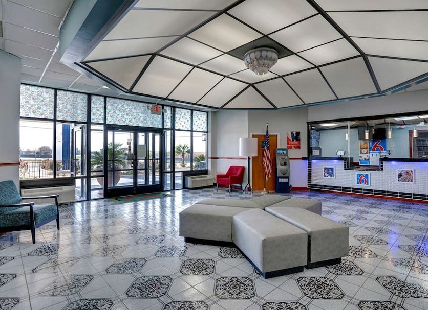 Motel 6 Burlington NC lobby with check-in desk, seating area and patterned tile floor in Burlington