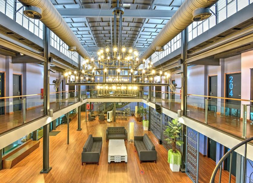 Quayside Hotel Malacca atrium lobby with hanging lights, mezzanine walkways and seating