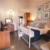 Bandarawela Hotel in Bandarawela room with white metal bed, wood furniture and framed wall art