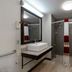 Red Roof Inn Kenly - I-95 bathroom with walk-in shower, vessel sink, mirror, and grab bar