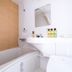 Meet Inn Narita bathroom with bathtub, shower, sink, mirror and toiletries in Narita