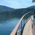 Casa De Casal De Loivos terrace with curved railing overlooking a calm lake and green hills in Casal de Loivos