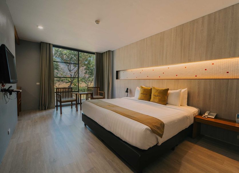 Sukhothai Treasure Resort & Spa in Sukhothai guest room with king bed, desk, and large window view