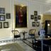 Ananda in the Himalayas in Rishikesh lounge with ornate decor, blue sofa, portrait, and large windows