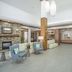 Hilton Garden Inn Clifton Park lobby with seating area and stone fireplace
