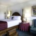 Sea Cliff Gardens Bed & Breakfast in Port Angeles guest room with four-poster bed and armchair