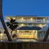 Seashell Village Resort in Port Aransas, beachside rooms lit at dusk with a pool and palm trees