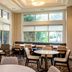 Residence Inn by Marriott Norfolk Airport breakfast lounge with tables, chairs and large windows