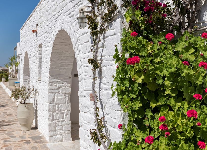 Saint Andrea Seaside Resort - Adults Only in Parikia, whitewashed arches with flowering vines by a stone path