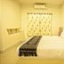 Rinlada House Chiang Rai simple guest room with double bed, window curtain, and wall-mounted air conditioner