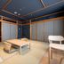 Ryokan Ryokufuso in Kyoto tatami room with low table, floor chairs, and sliding doors