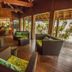 Maitai Rangiroa lounge in Avatoru with wicker seating and open-air wooden interior