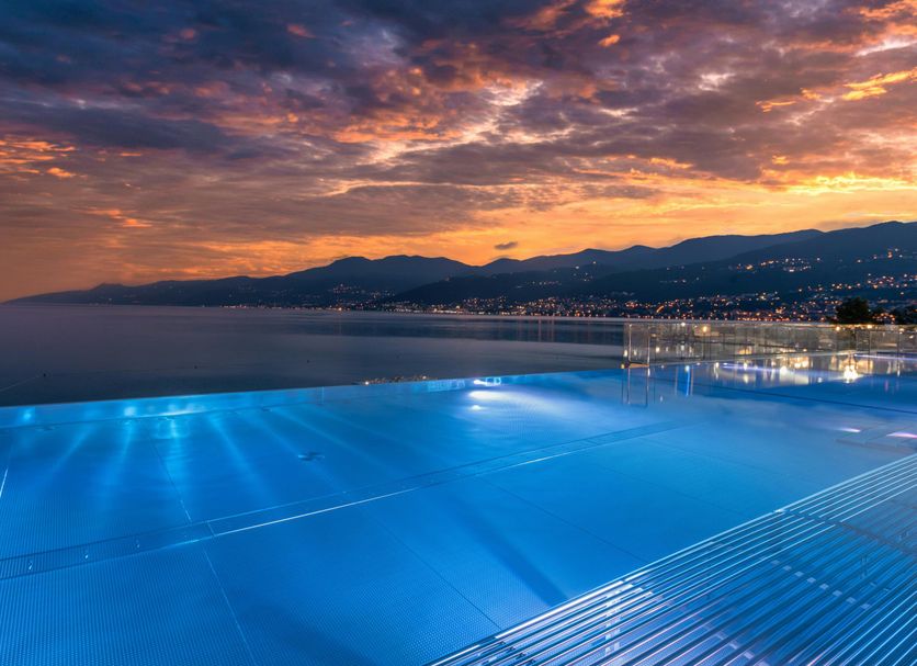 Hilton Rijeka Costabella Beach Resort & Spa infinity pool overlooking the Adriatic at sunset in Rijeka