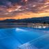 Hilton Rijeka Costabella Beach Resort & Spa infinity pool overlooking the Adriatic at sunset in Rijeka
