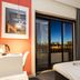 Stay Hotel Coimbra Centro room with bed, desk, and balcony view over Coimbra at night
