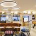 ibis Paris Gare de Lyon Diderot 12ème bar lounge in Paris with tufted sofa, round tables and lit shelves