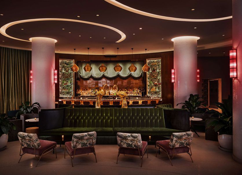Nautilus Sonesta Miami Beach lounge with curved ceiling lights and bar in Miami Beach