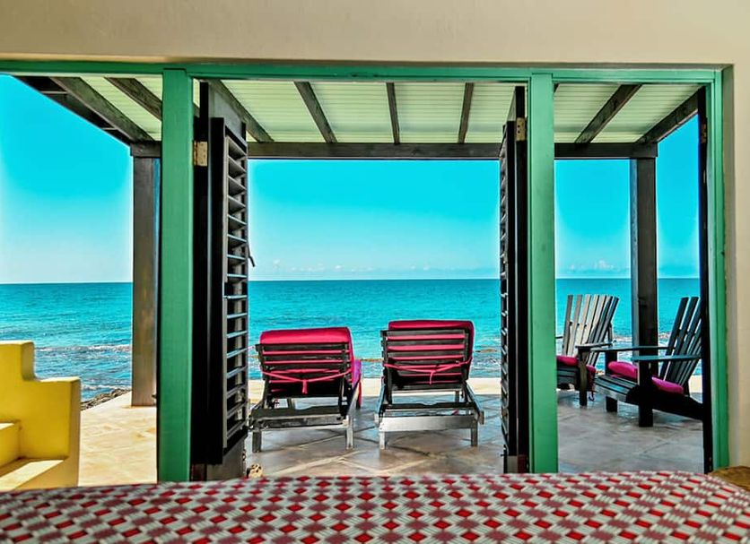 Jakes in Treasure Beach with oceanfront deck and lounge chairs overlooking the sea