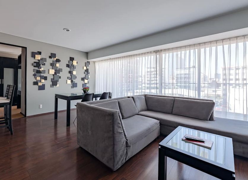 Suites Parioli Mexico City living room with sofa and city view through large windows
