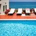 Kenta Beach Hotel in Agios Ioannis with ocean-view pool and lounge chairs
